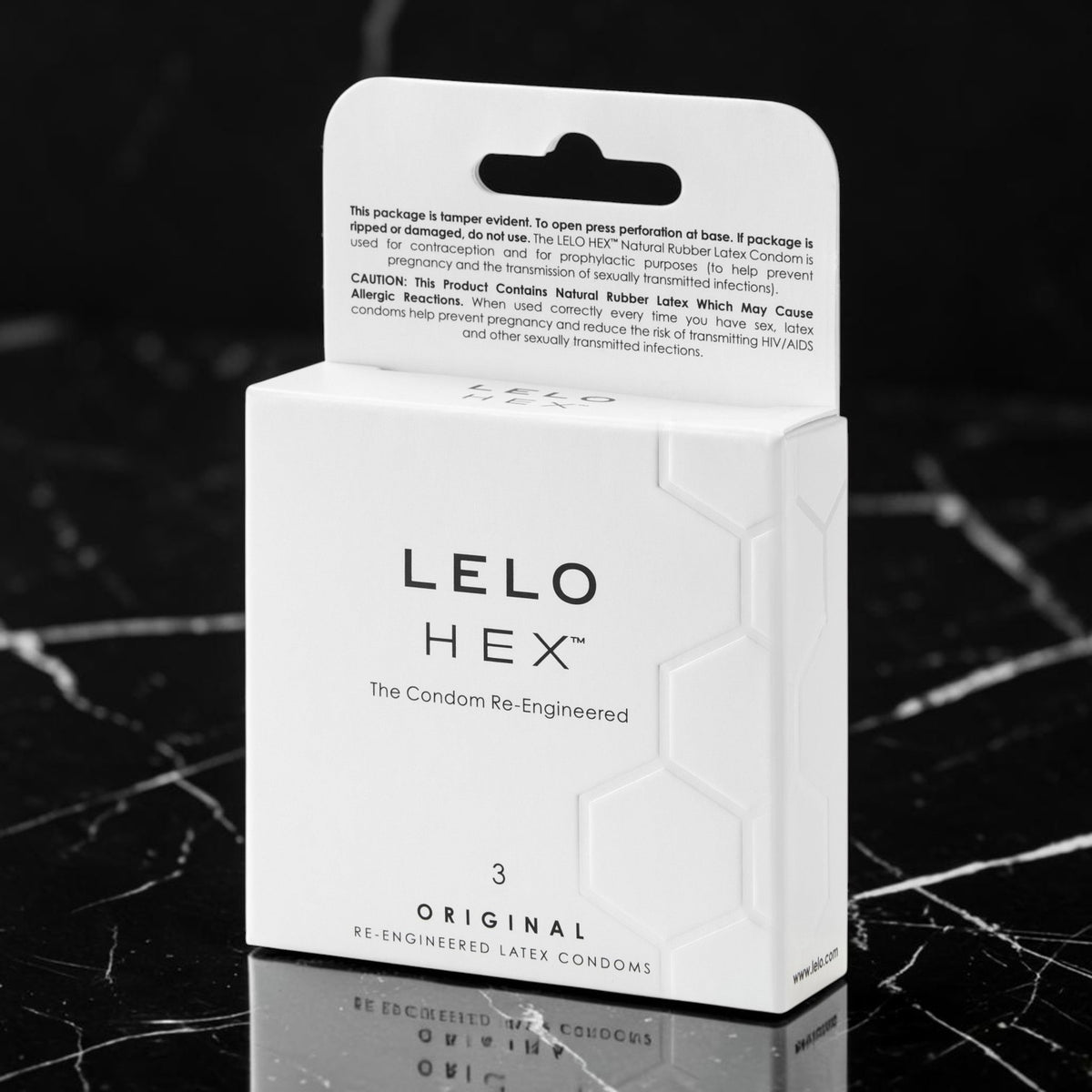 A white box of LELLO HEX Original Re-Engineered Later Condoms on a black marble surface, with the back of the packaging visible above the front.
