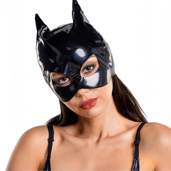 A woman wearing a glossy black latex Batman-style cowl mask with pointed ears, shown against a plain white background.