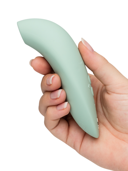 We-Vibe Melt 2 - Mint green Hand holding a light green silicone wrist rest on a white background