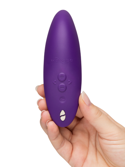 We-Vibe Melt 2 - Purple remote control held in a hand against a white background