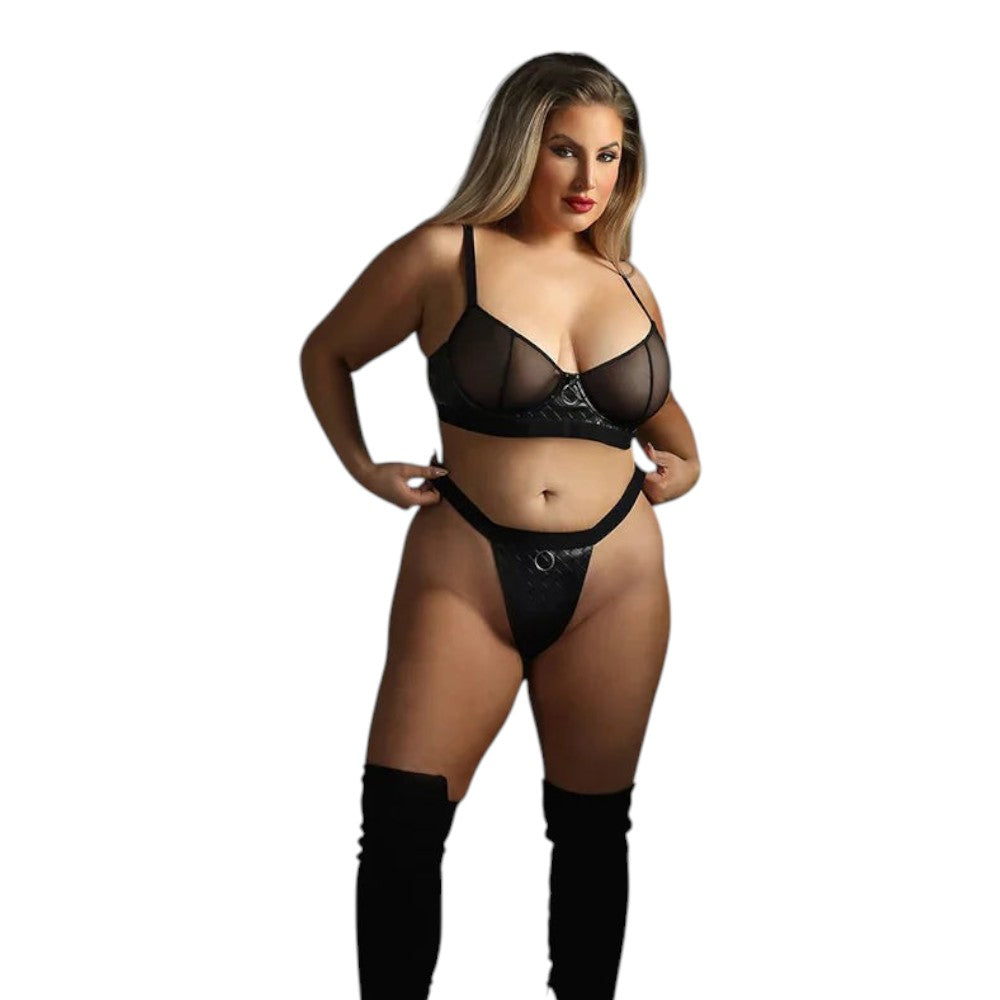 A woman modeling a black sheer lingerie set with matching black thigh-high stockings against a plain white background.