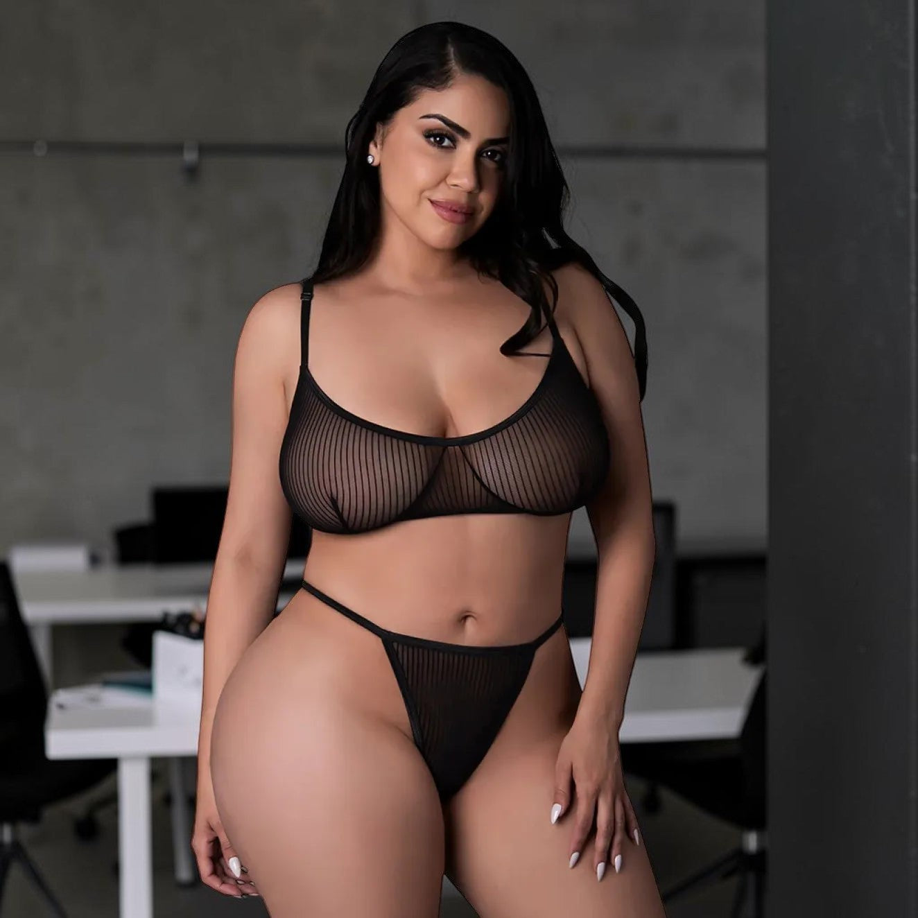 Model wearing a black striped mesh lingerie set by PlayLoveToys, featuring a soft-cup bralette and a thong.