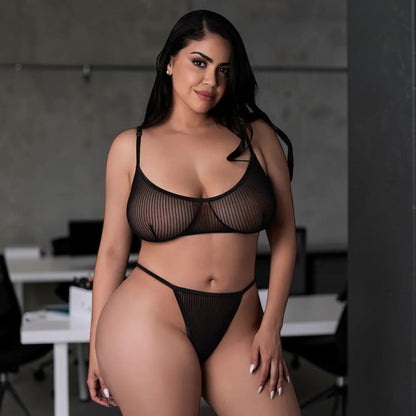 Model wearing a black striped mesh lingerie set by PlayLoveToys, featuring a soft-cup bralette and a thong.