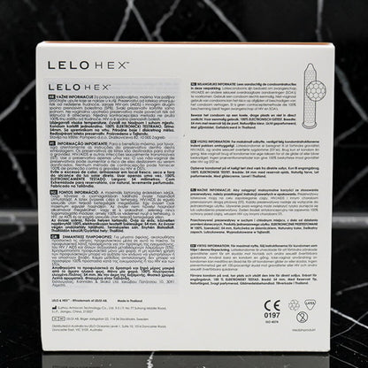The back of a white LELO HEX box, featuring extensive product instructions in Portuguese and English, a product diagram, and certification logos, set against a dark textured background.