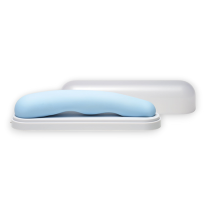 iroha TSUKI - Internal Vibrator G-Spot Stimulation A light blue curved silicone insert resting on a white rectangular base, with a translucent white cap or cover behind it on a plain white background.