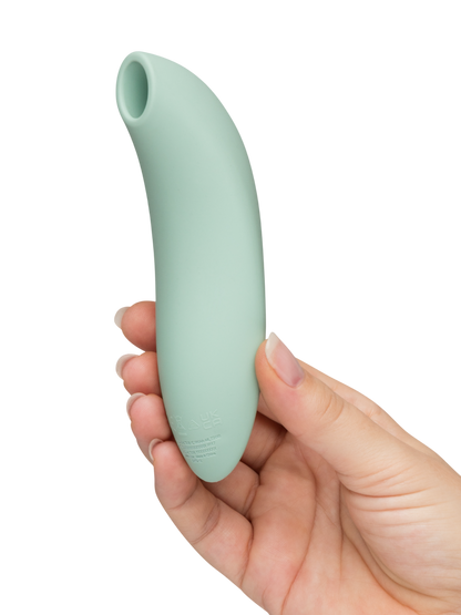 We-Vibe Melt 2 - Mint green  Hand holding a light green silicone tool against a white background